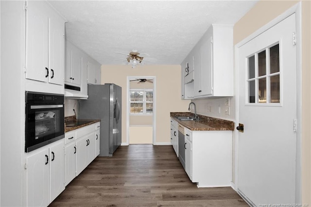 kitchen with sink, black appliances, dark hardwood / wood-style floors, and white cabinets