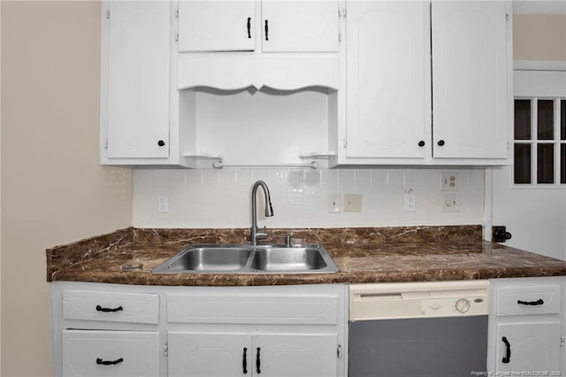 kitchen featuring dishwashing machine, sink, decorative backsplash, and white cabinets