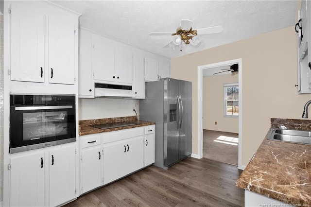 kitchen featuring sink, black appliances, dark hardwood / wood-style flooring, ceiling fan, and white cabinets