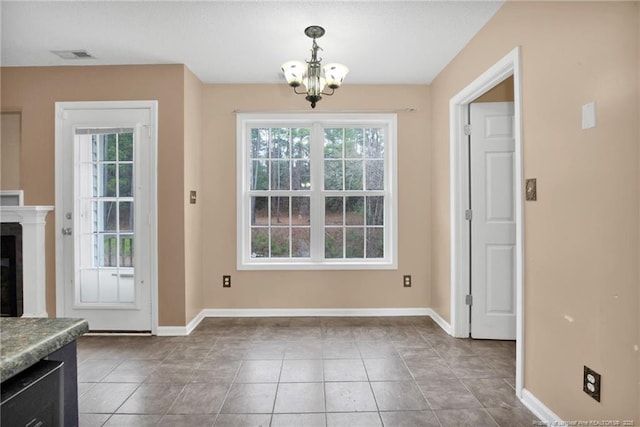 entryway featuring an inviting chandelier and tile patterned floors