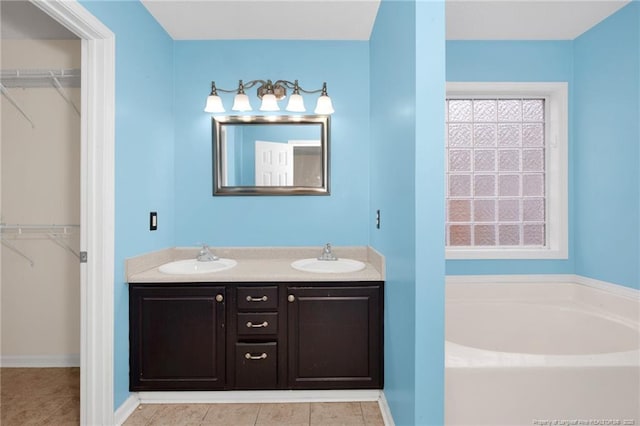 bathroom with vanity, tile patterned floors, and a bathing tub