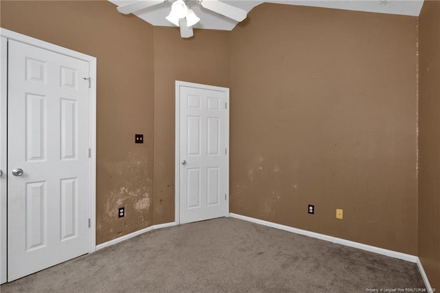 unfurnished bedroom with ceiling fan, carpet flooring, and vaulted ceiling