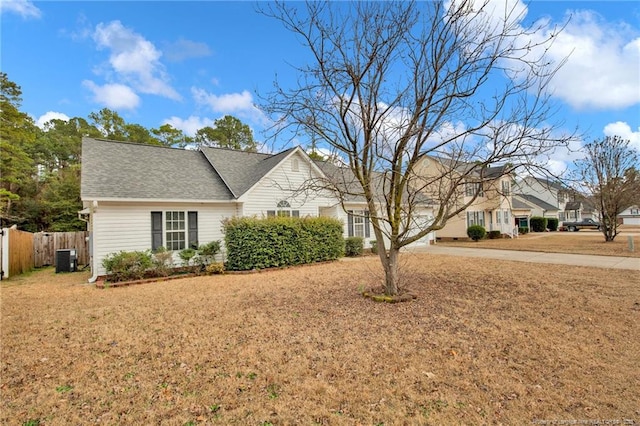 view of front of property with cooling unit and a front lawn