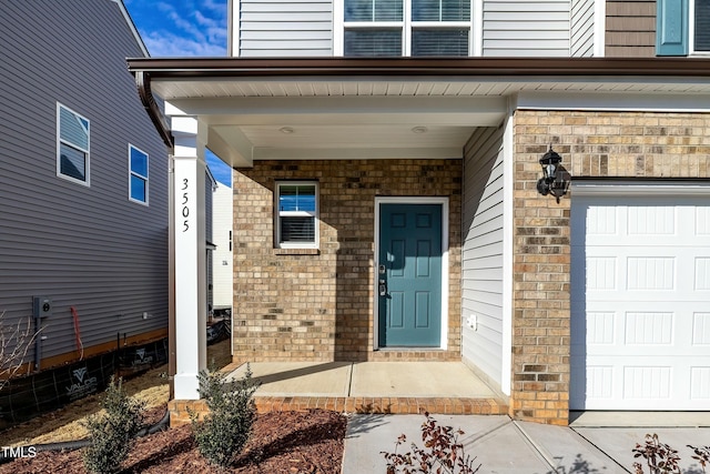 entrance to property with a garage and covered porch