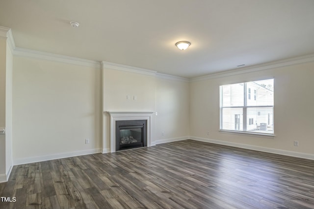 unfurnished living room featuring crown molding and dark hardwood / wood-style flooring