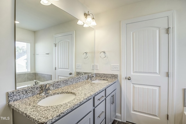 bathroom with vanity and a bath