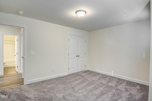 unfurnished bedroom featuring carpet floors and a closet