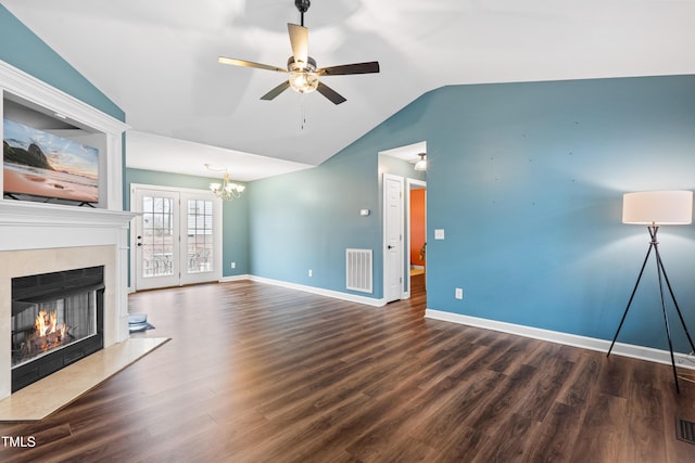 unfurnished living room featuring lofted ceiling, a high end fireplace, visible vents, baseboards, and dark wood finished floors