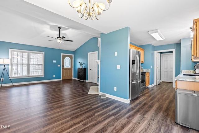 kitchen with dark wood-style flooring, a sink, open floor plan, light countertops, and appliances with stainless steel finishes