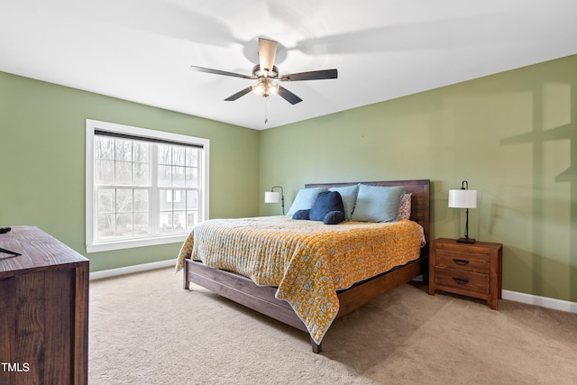 bedroom featuring light carpet, ceiling fan, and baseboards