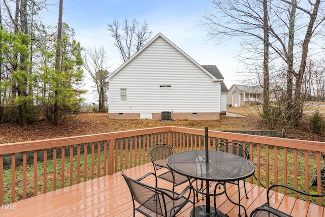 wooden deck with outdoor dining area and central AC