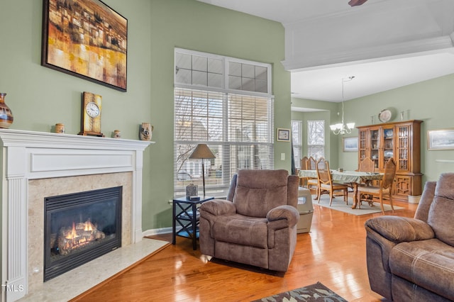 2815 Mebane Ln, Durham, NC 27703 - living room with light wood-type flooring, a chandelier, and a fireplace