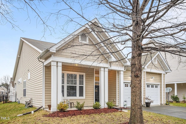 2815 Mebane Ln, Durham, NC 27703 - view of front facade featuring asphalt driveway, an attached garage, a porch, and a front lawn