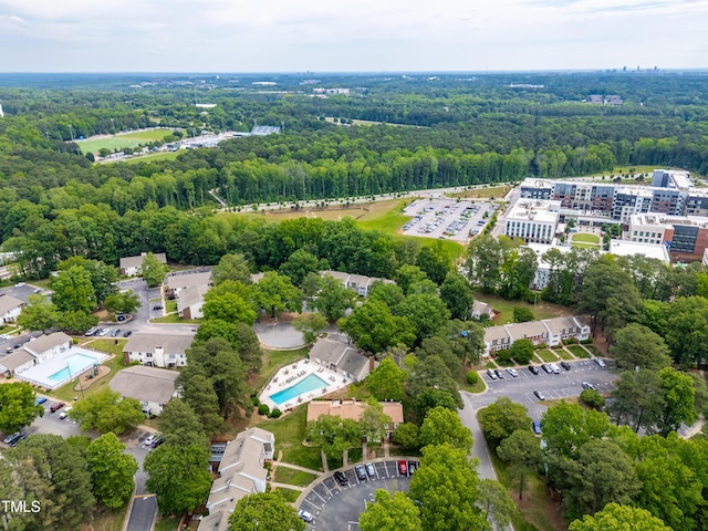 bird's eye view of a pool and a forest