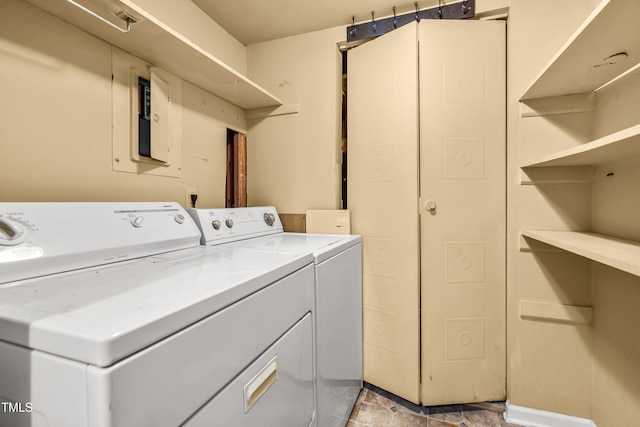 laundry area with washing machine and dryer and baseboards