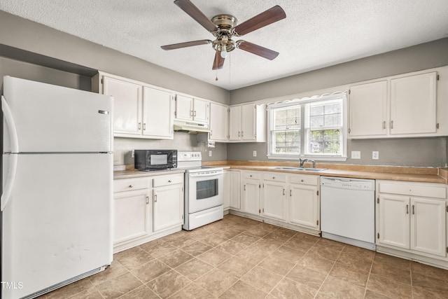 kitchen featuring white appliances, a sink, under cabinet range hood, white cabinetry, and a textured ceiling