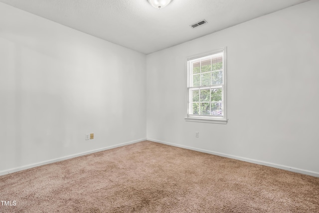 unfurnished room featuring carpet floors and baseboards