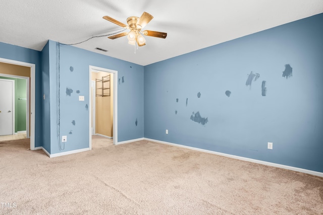 unfurnished bedroom featuring carpet flooring, baseboards, and a ceiling fan