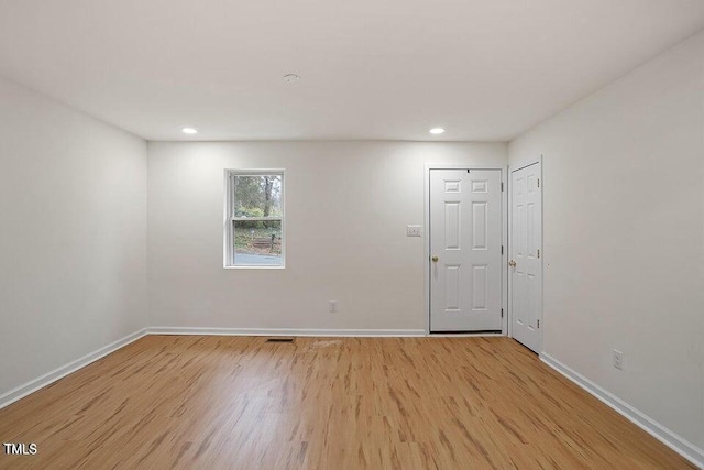 spare room featuring light wood-type flooring