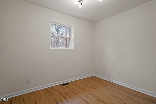 empty room with hardwood / wood-style flooring