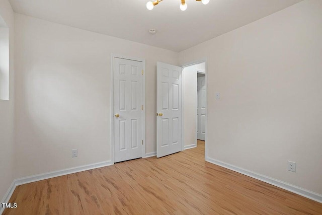 unfurnished bedroom with light wood-type flooring