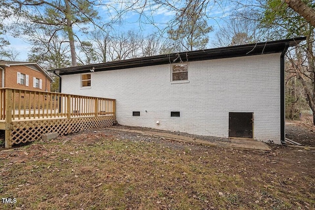 rear view of house featuring a wooden deck