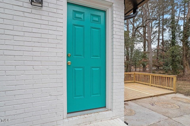 view of exterior entry with a deck