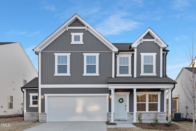 craftsman inspired home featuring a garage and central air condition unit