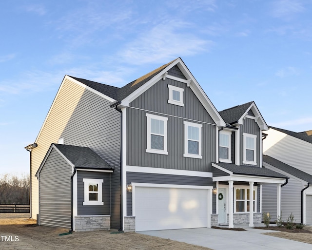 view of front of home with a porch and a garage