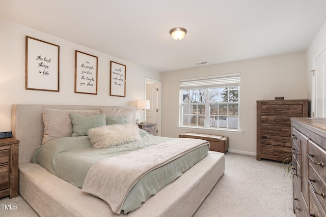 bedroom with baseboards and light carpet