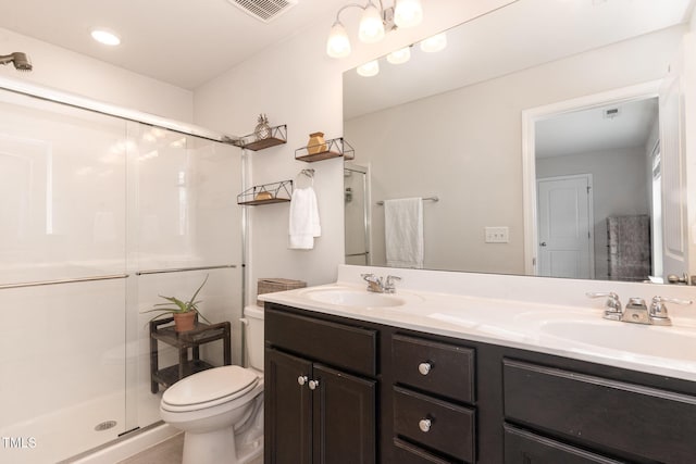 bathroom with a sink, visible vents, toilet, and a shower stall