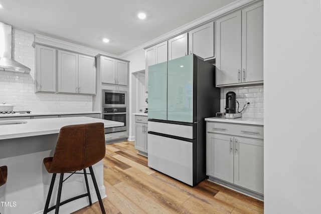 kitchen featuring gray cabinetry, refrigerator, and oven