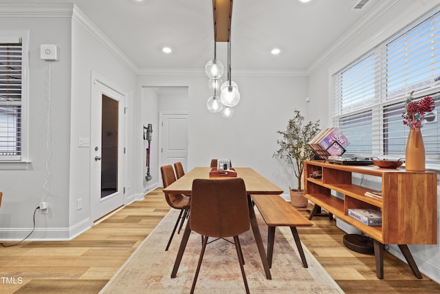 dining space featuring crown molding and plenty of natural light