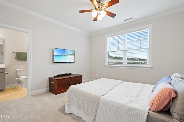 carpeted bedroom featuring crown molding, connected bathroom, and ceiling fan