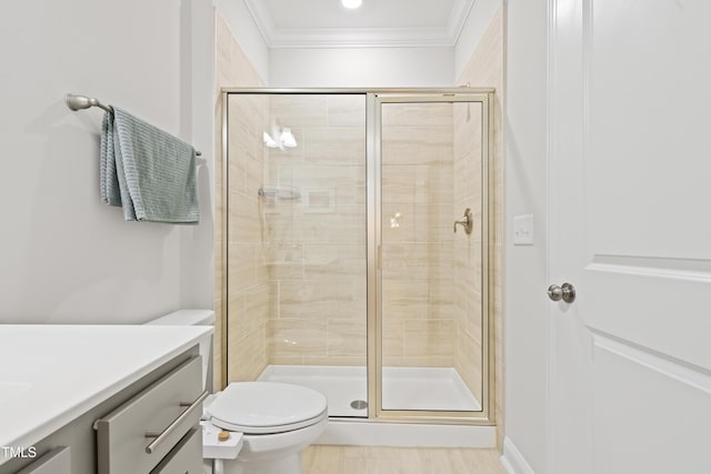 bathroom with crown molding, toilet, vanity, and walk in shower