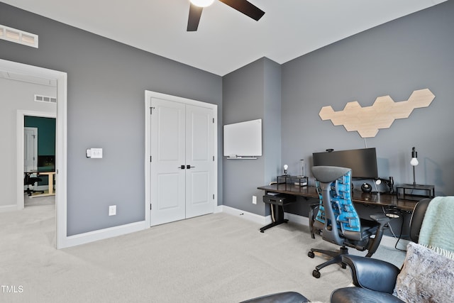 carpeted office featuring ceiling fan