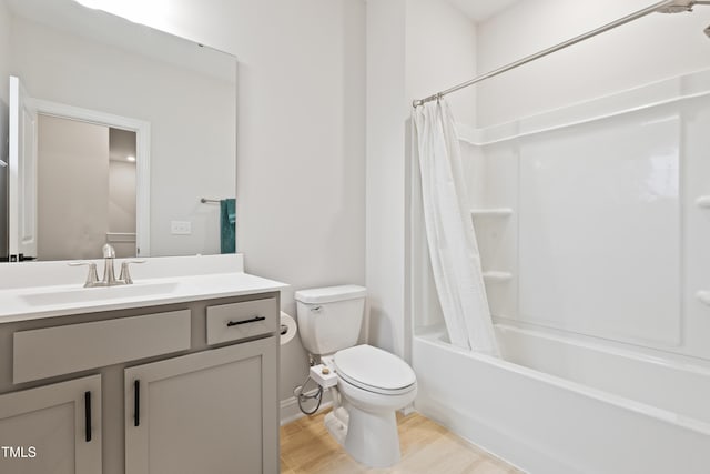 full bathroom with shower / bath combo, wood-type flooring, vanity, and toilet