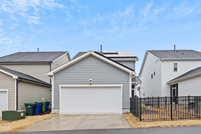 front of property featuring a garage and solar panels