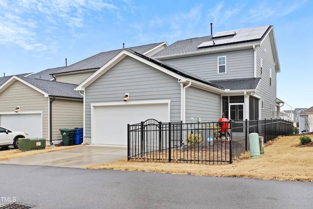 view of front of house with a garage and solar panels