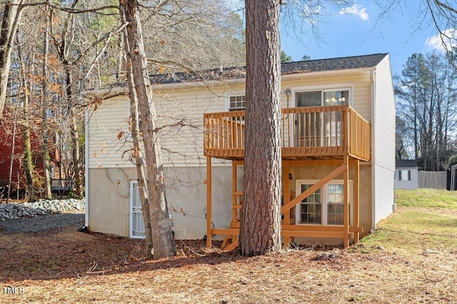 back of house featuring a balcony