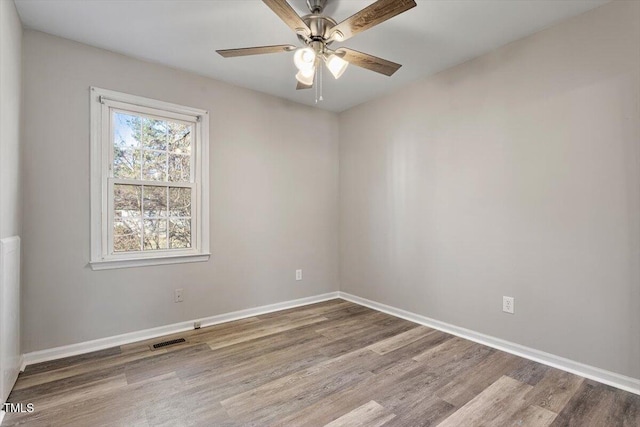 spare room featuring hardwood / wood-style floors and ceiling fan