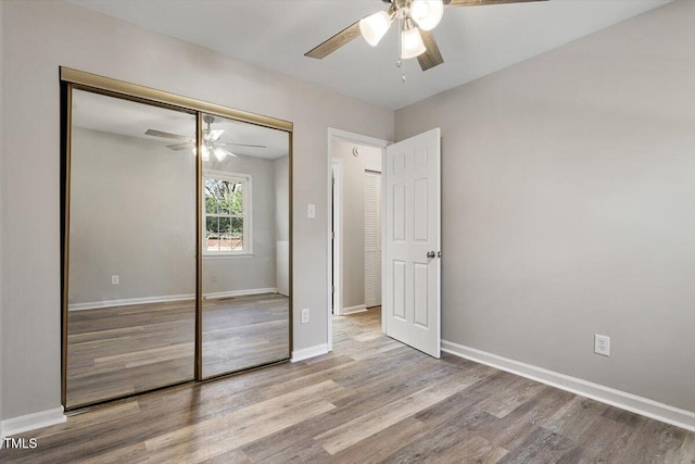 unfurnished bedroom featuring a closet, ceiling fan, and light hardwood / wood-style flooring