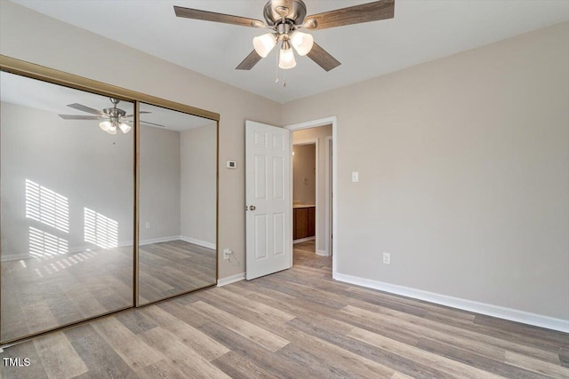 unfurnished bedroom featuring ceiling fan, light wood-type flooring, and a closet