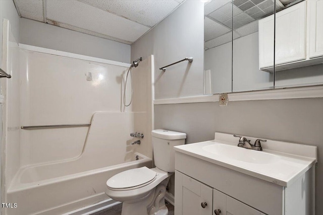 full bathroom with toilet, a paneled ceiling, vanity, and bathtub / shower combination