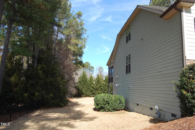 view of property exterior featuring crawl space and fence