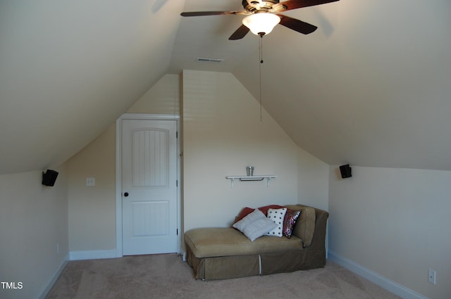 sitting room with light colored carpet, visible vents, lofted ceiling, and baseboards