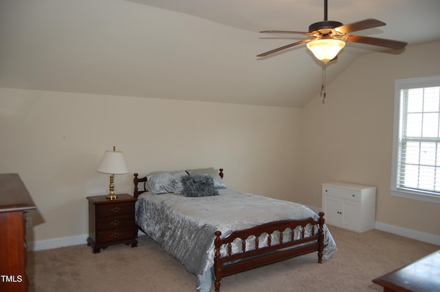 bedroom featuring light carpet, multiple windows, and lofted ceiling