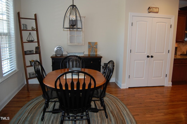 dining area with dark wood-style floors and baseboards