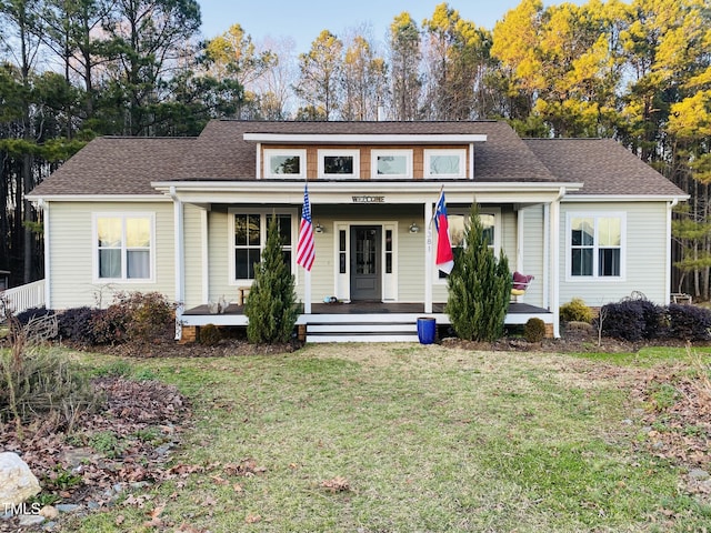 view of front of property with covered porch and a front lawn