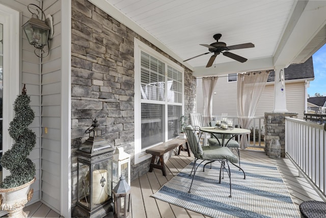 wooden deck with ceiling fan and a porch